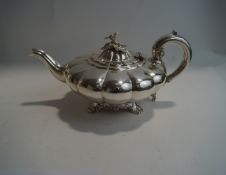 A Victorian silver teapot, by John James Keith, London 1838, of compressed melon shape,