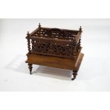A Victorian walnut canterbury with single drawer,