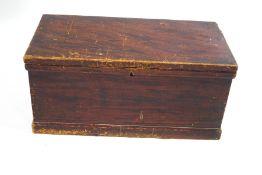 A pine blanket box with two handles, painted to simulate oak,