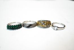 A collection of four stone set silver rings