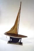 A 20th Century pond yacht, the hull painted silver with a black keep, on stand,