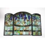 A Tiffany style stained glass three section fire screen, depicting fruiting vines,