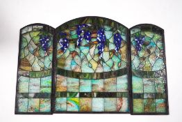 A Tiffany style stained glass three section fire screen, depicting fruiting vines,
