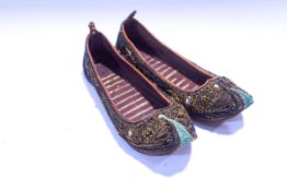 A pair of Middle Eastern or Indian children's shoes, leather and velvet with gold coloured wirework,
