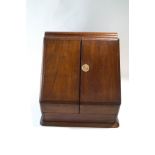An early 20th century mahogany stationery cabinet, with hinged doors enclosing fitted racks,