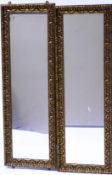 A pair of rectangular wall mirrors with moulded gilt gesso frames,