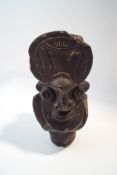 A tribal larval rock carved figure, possibly from Papa New Guinea,