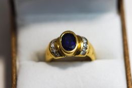 A sapphire and cubic zirconia dress ring, stamped '750', finger size J1/2, 6.