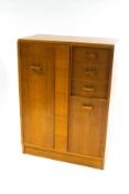 A mid-20th century G-plan chest of three drawers and two cupboards,