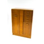 A mid-20th century G-plan chest of three drawers and two cupboards,