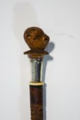 A slim cane with decorated shaft,