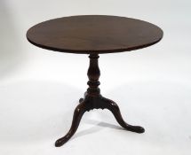 A 19th century mahogany tripod table with snap top upon a bird cage column,