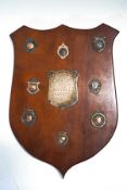 A mahogany shield with silver plaque, inscribed A.