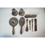 A silver dressing table set, comprising a pair of candlesticks, a hair brush, a clothes brush,