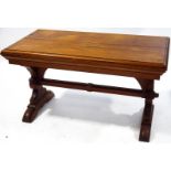 A pitch pine rectangular Gothic style table with deep moulded frieze above two legs,