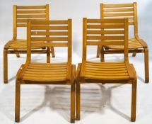 A set of four stacking chairs each with slat backs and seats,