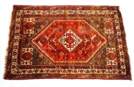A Turkoman rug with geometric motifs on a red field,