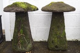 A pair of reconstituted staddle stones and caps,