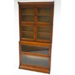 An oak Globe Wernick style four section glazed bookcase,