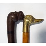 A carved hardwood walking stick, modelled with a hippo's head, and a further walking stick,