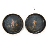 A pair of 18th century tole coasters, each decorated with chinoisere figures on a black ground,