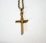 A crucifix pendant, stamped '9c'; on a 9 carat gold chain; 3.