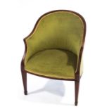 An Edwardian mahogany tub shaped chair with green upholstery