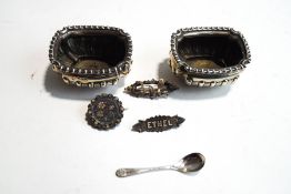 A pair of late Victorian silver salts; with a silver salt spoon; and three silver brooches,