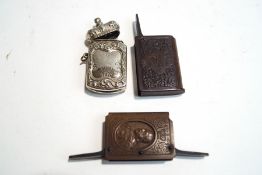 A collection of three Royal commemorative vesta cases, two in plastic and one in plated metal,