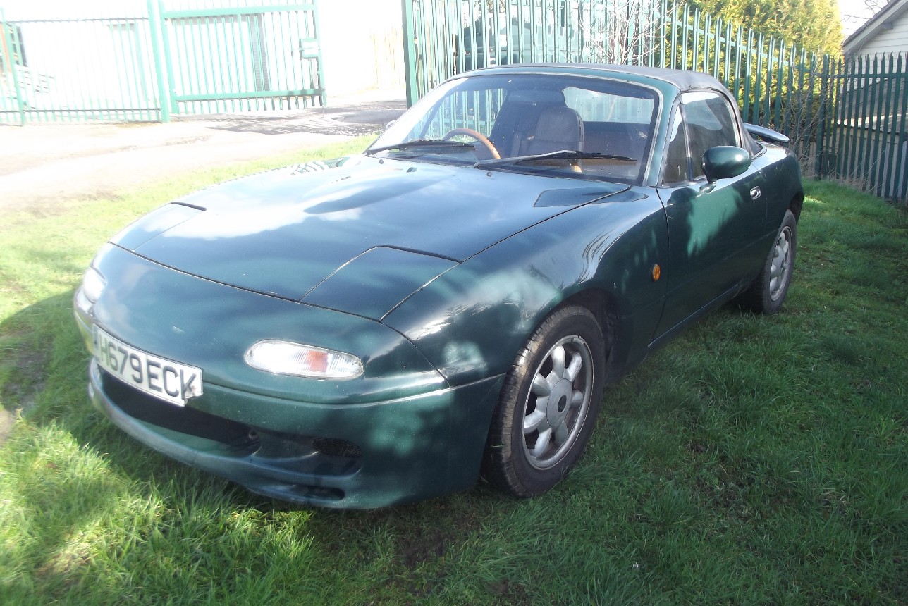A 1990 Mazda MX-5, registration number H679 ECK, green. Imported in 2001, this Mk.