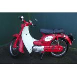 A 1970 Suzuki U50 Step Through, registration number HGL 977H, red.