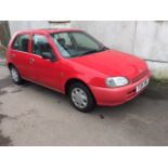 A 1999 Toyota Starlet 1.3 GLS Auto, registration number T128 JNA, red.