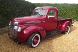 A 1942 Chevrolet AK Series Pick Up Custom, registration 501 YUX, chassis number BD39653, red.