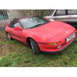 A 1992 Toyota MR2 T-Bar, registration number J748 EYD, red. A project car for recommissioning.