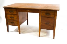 A mid 20th century mahogany desk with two drawers to one side and three to the other,