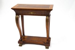A reproduction French style mahogany console table, with brass mounts and lion paw feet,