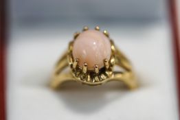 A 9 carat gold cabochon rhodochrosite ring, finger size N, 5.