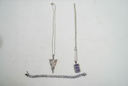 Two silver stone set pendants on chains,