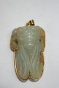 A Chinese jade carving of a cicada, within an unmarked gold mount,