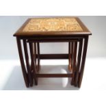 A G-Plan nest of three tables with inset tiled tops,