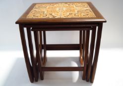 A G-Plan nest of three tables with inset tiled tops,