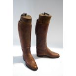 A pair of brown leather riding boots,