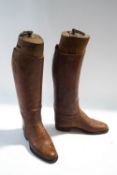 A pair of brown leather riding boots,
