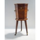 A George III style mahogany hexagonal wine cooler, on tripod base with brass castors,