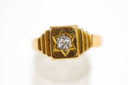 A diamond signet ring, stamped '18ct', the star set old cut diamond of approximately 0.