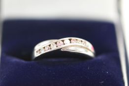 A 9 carat white gold ring, alternate channel set with pink and colourless cubic zirconia,