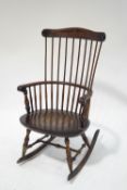An early 20th century stained beech rocking chair with combe back