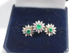 An 18 carat gold emerald and diamond cluster ring and matching ear studs,