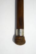 A Malacca shafted walking stick with silver collar (Chester 1923) and walnut modelled knop