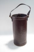 A cylindrical leather stick stand, with swing handle, 41cm high,